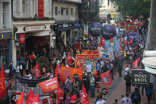 Anti-conservative protesters with placards and trade union banners march through Birmingham, central England, on Sunday on the first day of the Conservative Party annual conference (AFP photo)